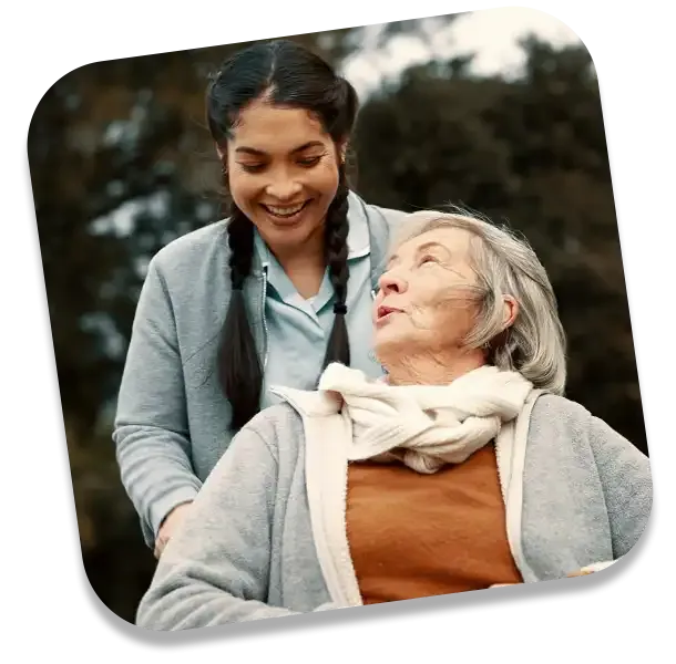 Carer pushing an elderly woman in a wheelchair – compassionate respite care in York for those with limited mobility.