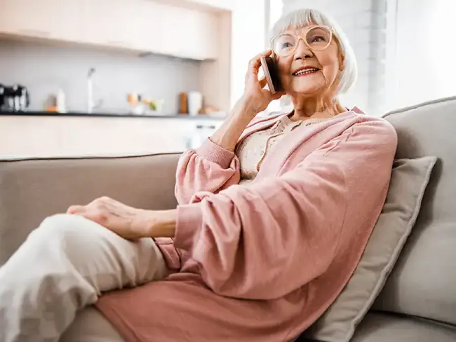 Carer providing hospital discharge advice and guidance to older couple at home