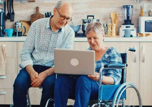 couple with long term health conditions on laptop