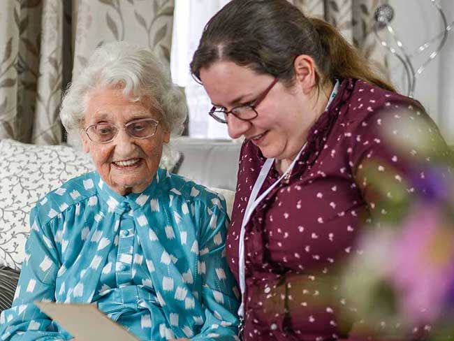 Carer and client going over the 10 Benefits of a home care service