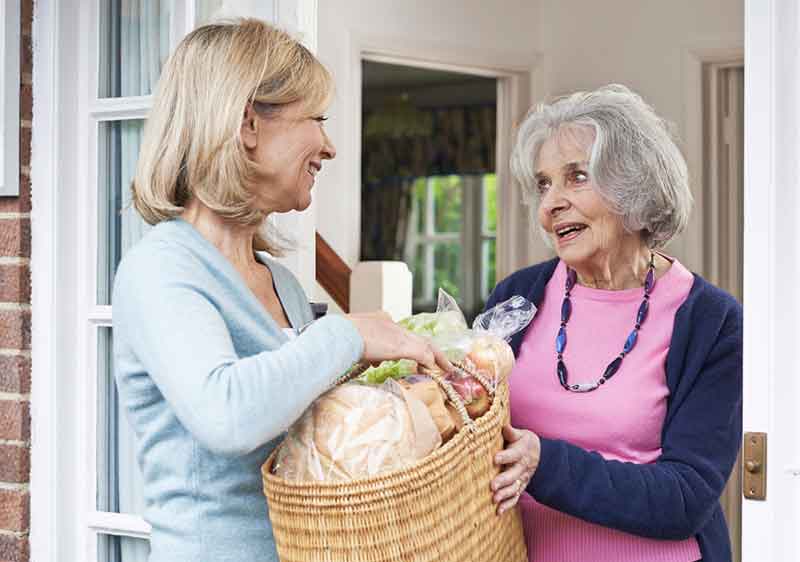 lady receiving shopping support from carer