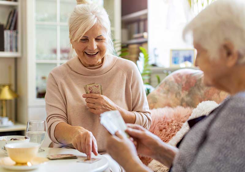 home carer playing cards with client