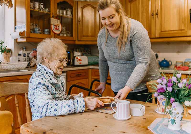 home carer helping Rosemary while she talks about her health care story