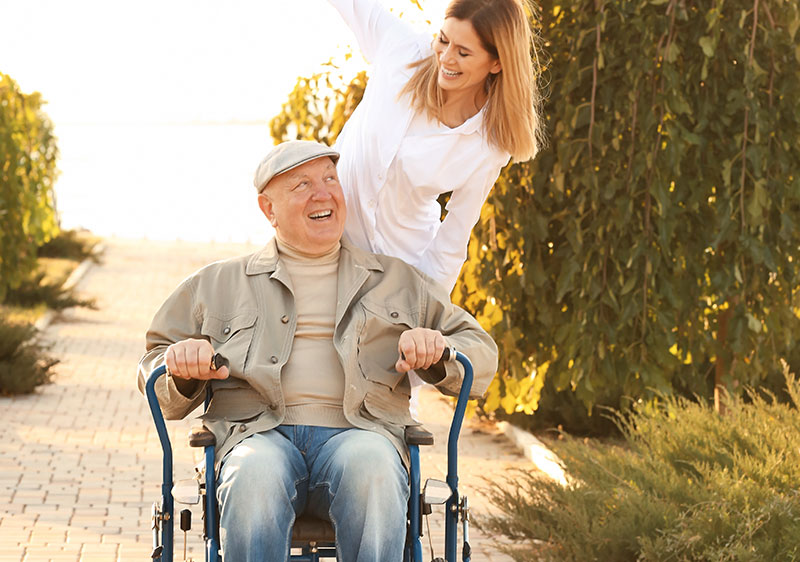 man with longterm health condition smiling with carer