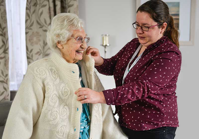 Home Care York - Carer helping client with jacket