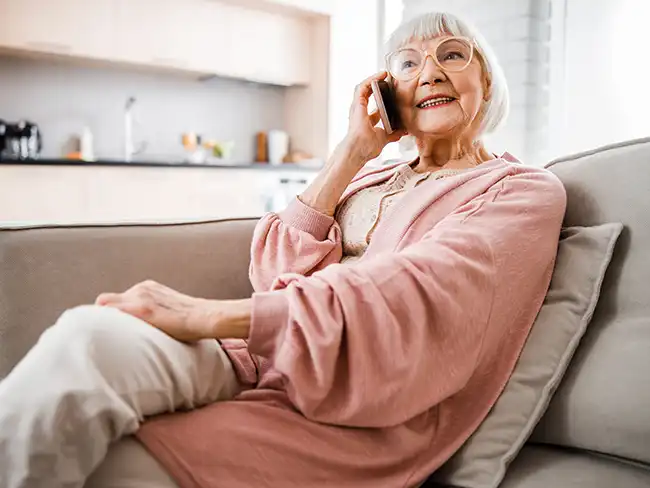 Carer providing hospital discharge advice and guidance to older couple at home
