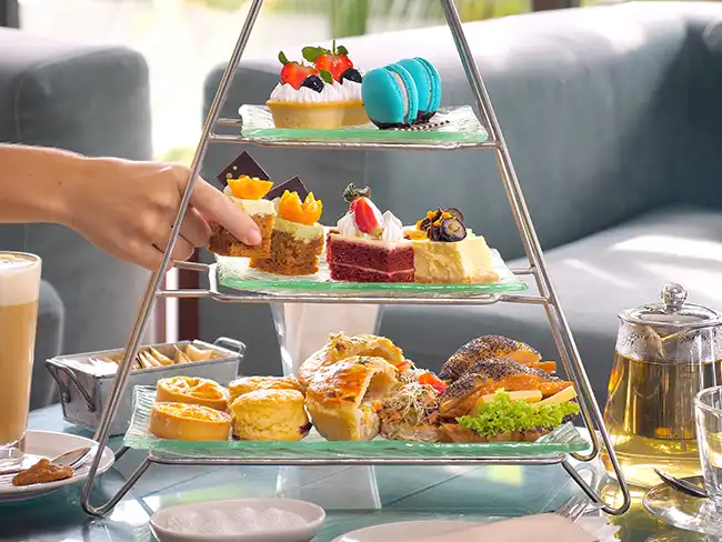 Afternoon tea treats on a tiered stand, representing Christmas gift ideas for older loved ones who enjoy shared experiences