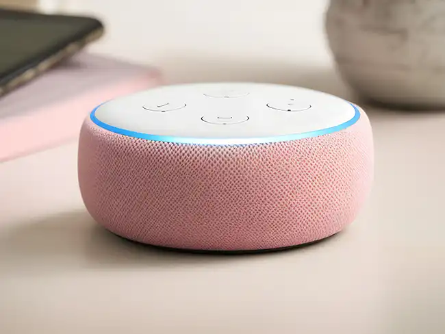 Pink smart speaker on a table, shown as one of the Christmas gift ideas for older loved ones to support music, reminders and independence.