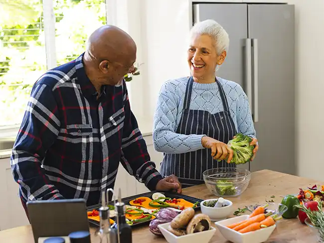 preparing vegetables together, illustrating Christmas gift ideas for older loved ones such as meal kits and shared cooking experiences.