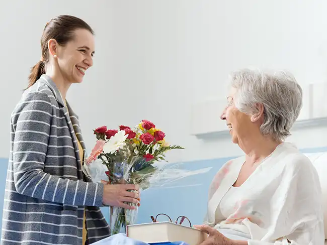 Carer delivering flowers as part of paying staff for their hobbies, creating thoughtful and unique moments for clients