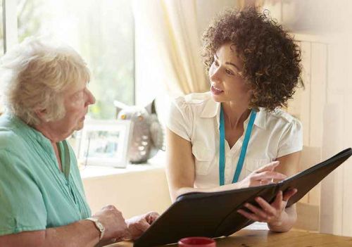 care assessor and client going over Care Cost Solutions