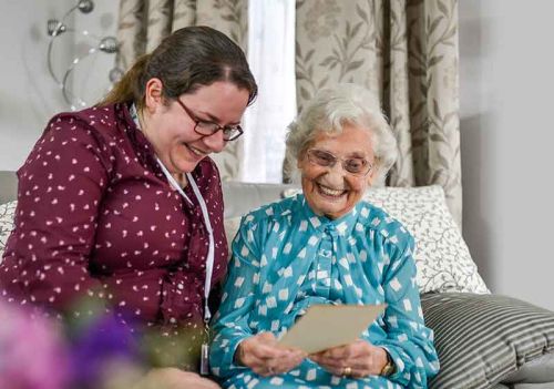 our journey - carer and happy client looking at cherished photograph
