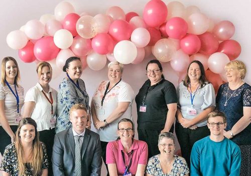 Care team celebrating CQC outstanding in care